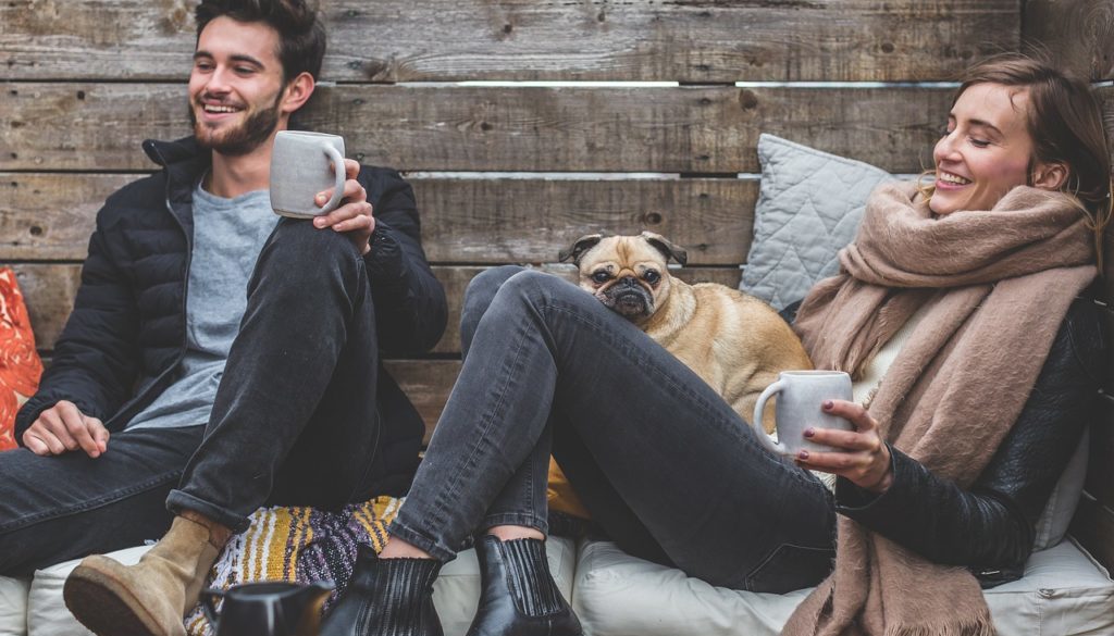 Couple with a dog laughing