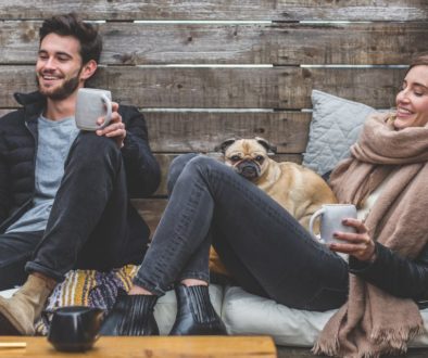 Couple with a dog laughing