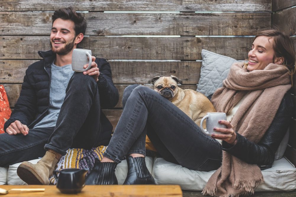 Couple with a dog laughing